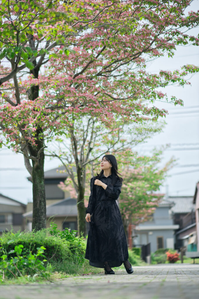 35mm判換算85mm相当の画角で、ハナミズキの木々と被写体のぬぬさんをドラマチックな距離感で切り取った写真。