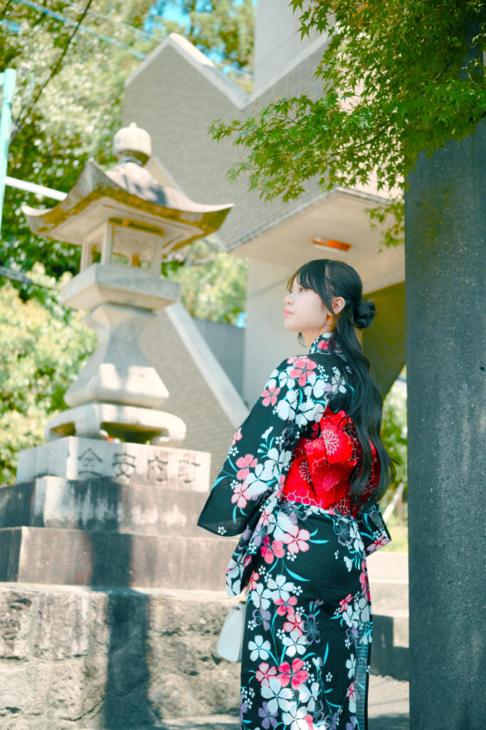 神社の参道で振り返り、パウダーブルーの設定が肌の透明感を引き立てるショット