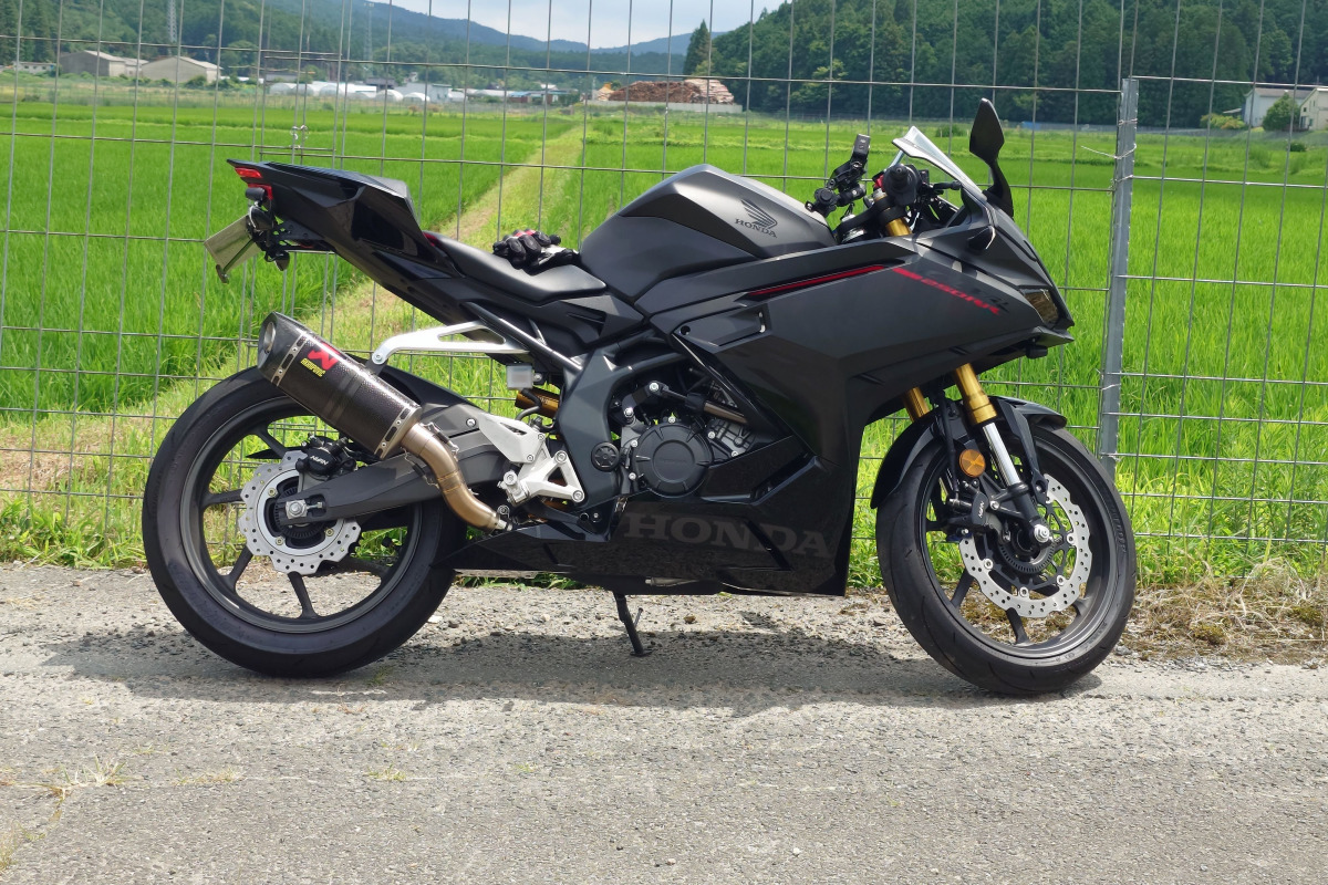 CBR250RRに装着されたパフォーマンスダンパーと田園風景をバックにした愛車
