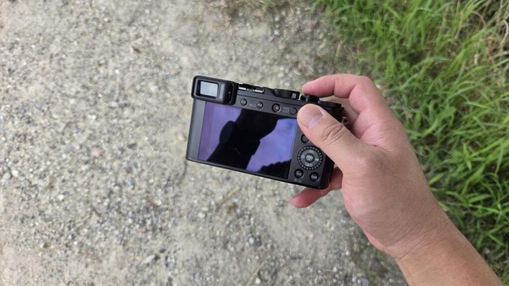 LUMIX LX100を右手で片手持ちしている屋外での様子