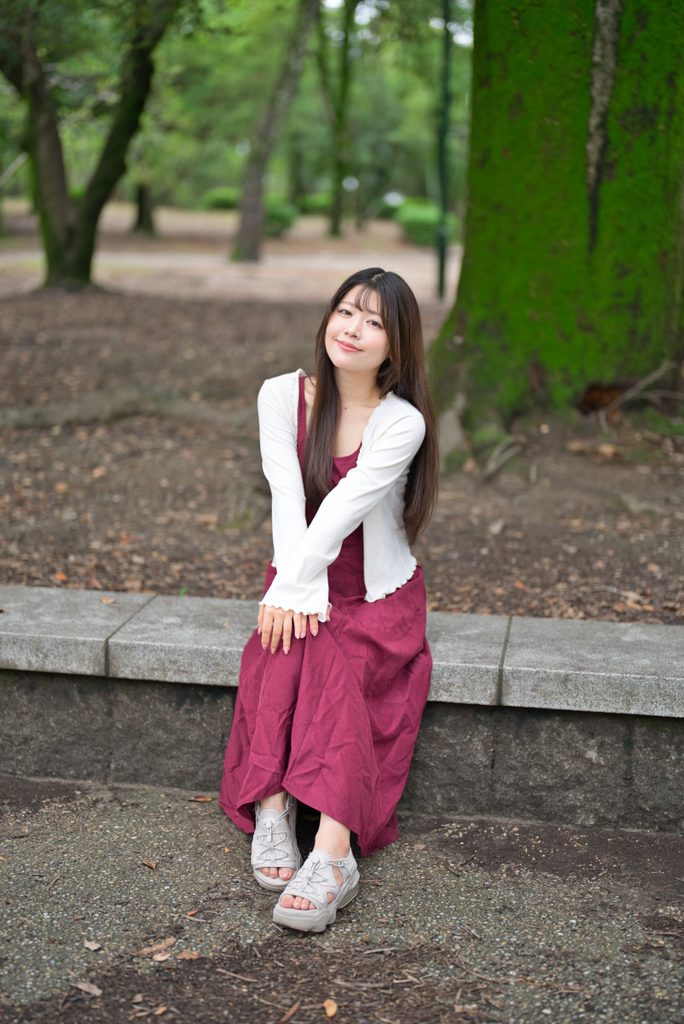 腰掛けに座る桜井こはるさんと背景の美しいボケグラデーション